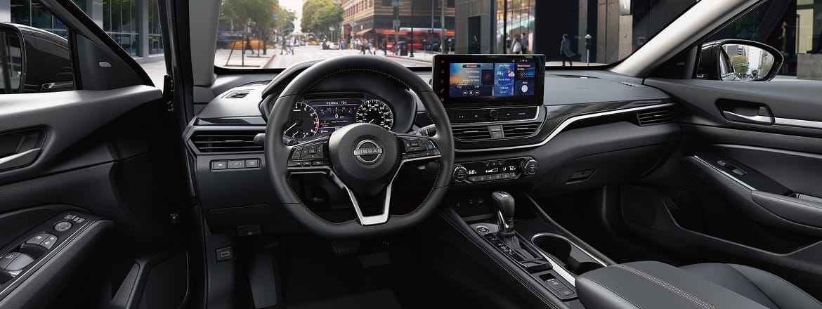 2026 Nissan Altima view from driver's seat showing gauges and 12 3-inch touch-screen illustrating connectivity.