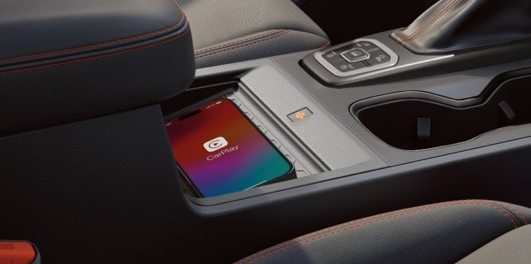 2026 Nissan Frontier detail interior view of smartphone on wireless charging pad.
