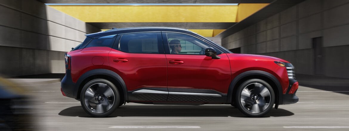 2026 Nissan Kicks driving through a concrete structure
